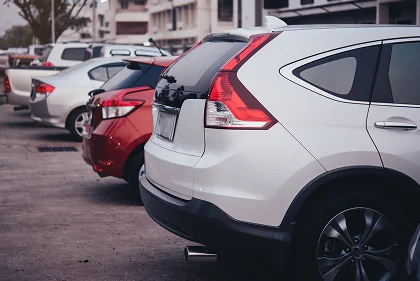 Row of used cars parked in a lot, eligible for extended warranty coverage